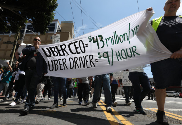 A banner at the Uber protest on May 8, contrasting the income of Uber's CEO and its drivers
