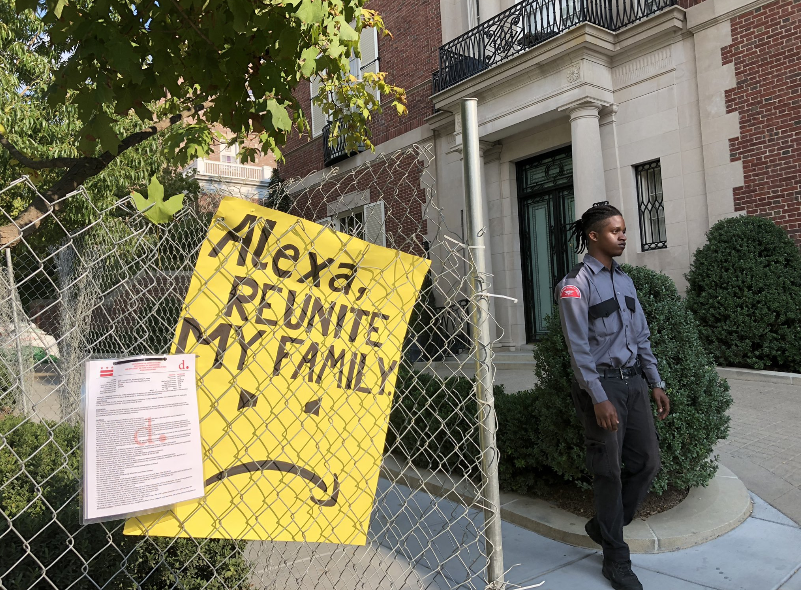 A poster on a fence reading 'Alexa, reunite my family'